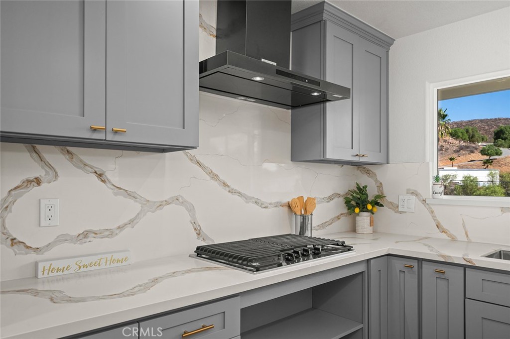 27875 Goetz Road Menifee, CA 92587 - Photo 13 of 74 a kitchen with a stove and cabinets