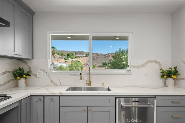 a kitchen with stainless steel appliances granite countertop a stove and a refrigerator