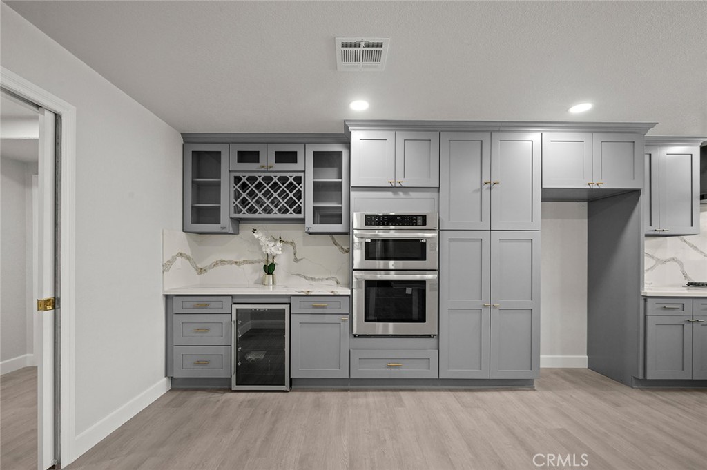 27875 Goetz Road Menifee, CA 92587 - Photo 16 of 74 a kitchen with stainless steel appliances granite countertop a stove and a refrigerator