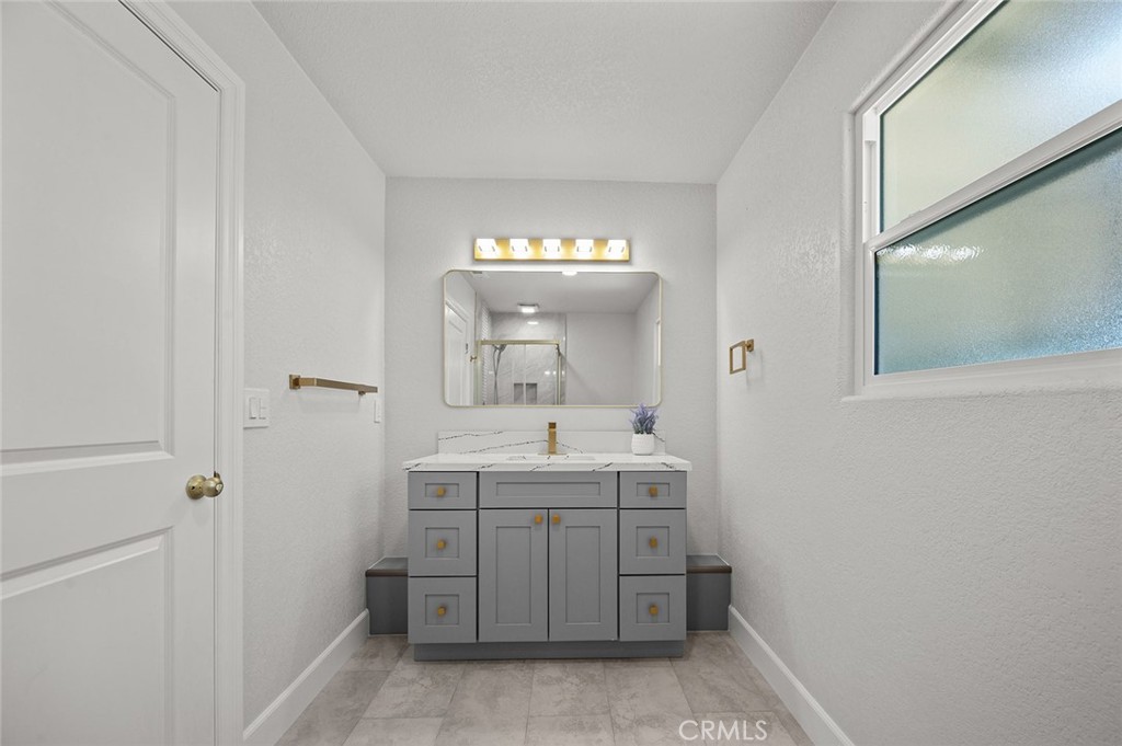 27875 Goetz Road Menifee, CA 92587 - Photo 17 of 74 a bathroom with a sink and a mirror