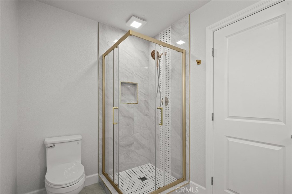27875 Goetz Road Menifee, CA 92587 - Photo 18 of 74 a bathroom with a shower a toilet and a shower