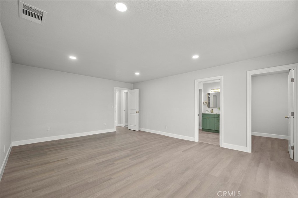 27875 Goetz Road Menifee, CA 92587 - Photo 31 of 74 a view of an empty room with wooden floor