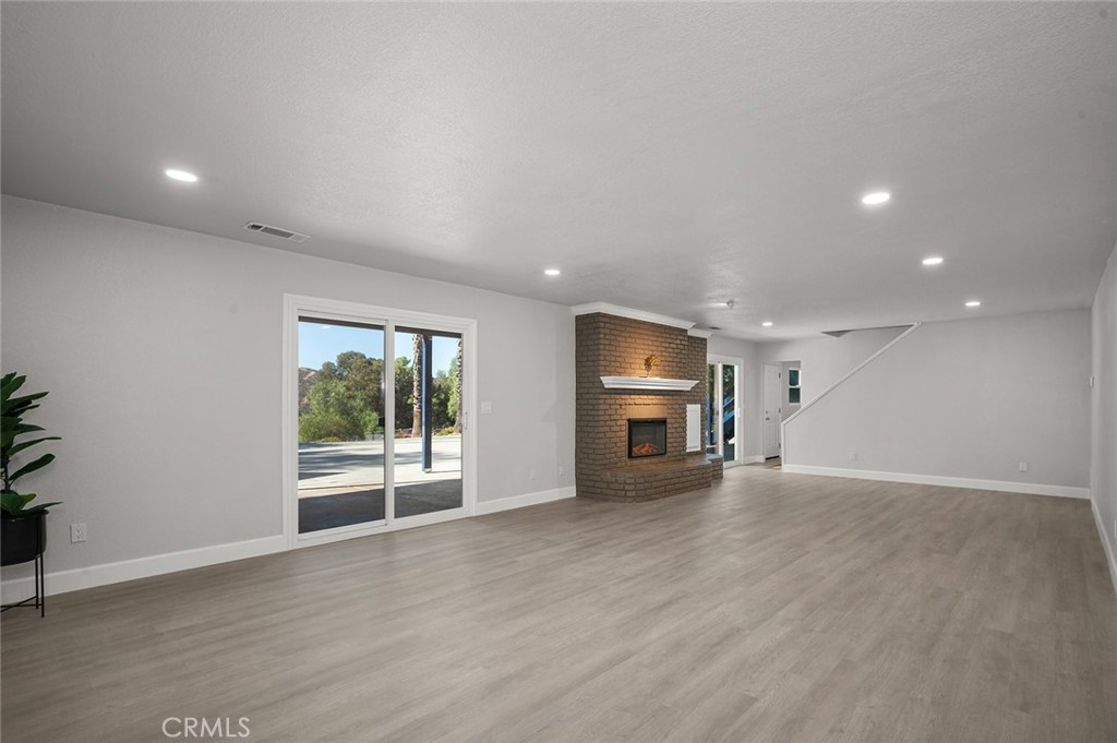 27875 Goetz Road Menifee, CA 92587 - Photo 39 of 74 an empty room with wooden floor and natural light