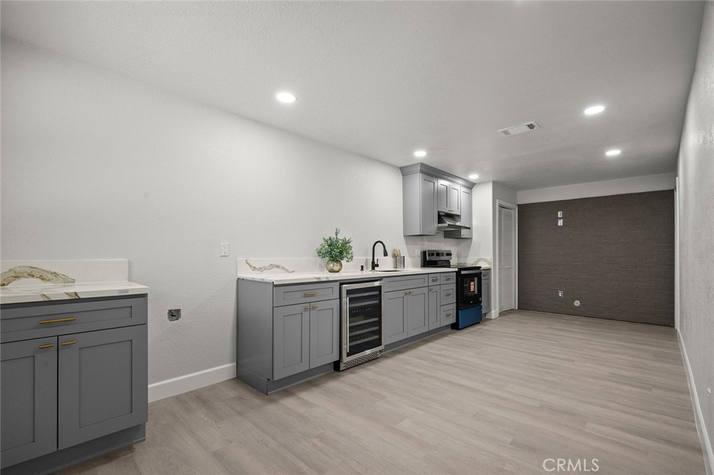 27875 Goetz Road Menifee, CA 92587 - Photo 40 of 74 a large kitchen with kitchen island a sink stainless steel appliances and white cabinets