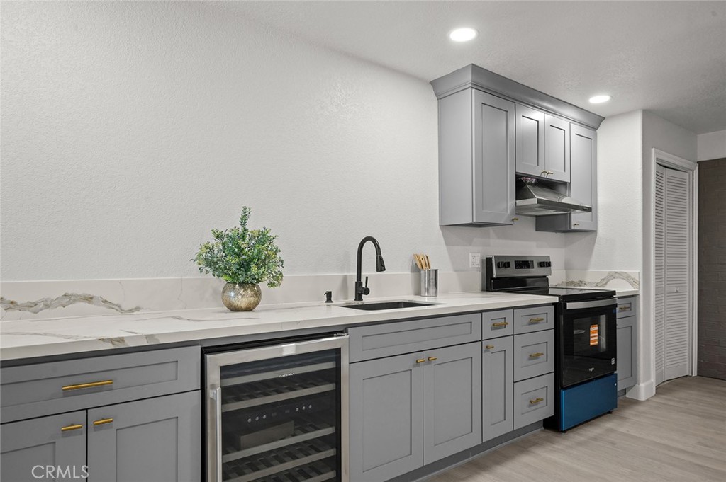 27875 Goetz Road Menifee, CA 92587 - Photo 42 of 74 a kitchen with kitchen island granite countertop white cabinets and white stainless steel appliances