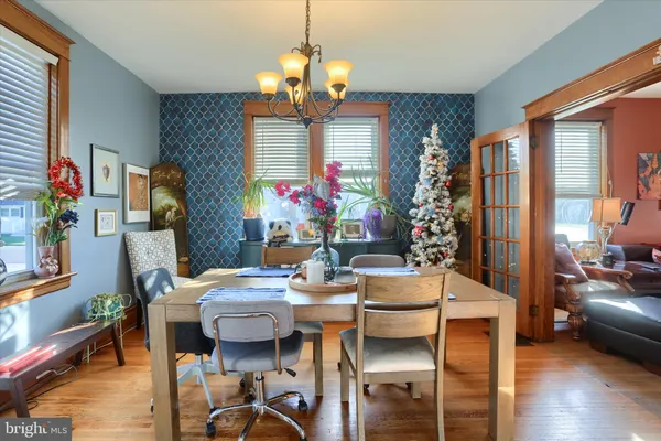 a view of a dining room with furniture and chandelier