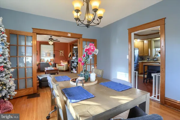 a view of a dining room with furniture wooden floor and chandelier
