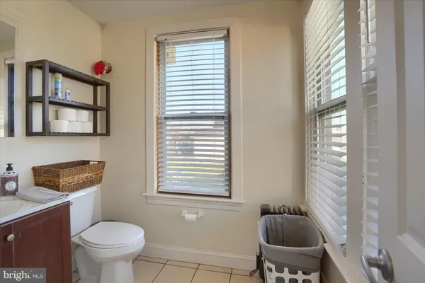a bathroom with a toilet a sink and a window