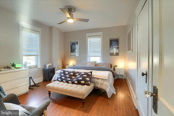 a bedroom with a bed and wooden floor