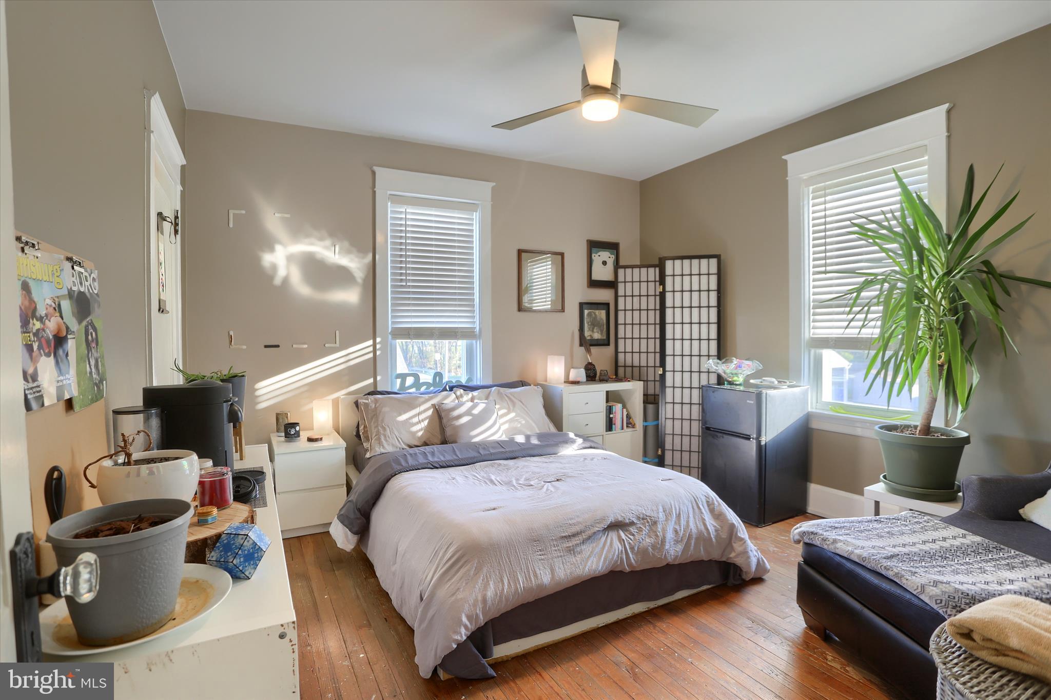 112 Lewisberry Road New Cumberland, PA 17070 - Photo 31 of 56 a spacious bedroom with a bed a couch and a potted plant