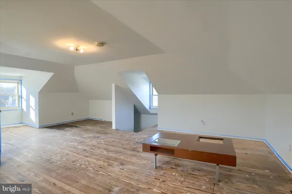 a view of room with stairs and wooden floor