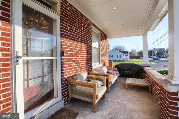 a balcony with furniture and a gate