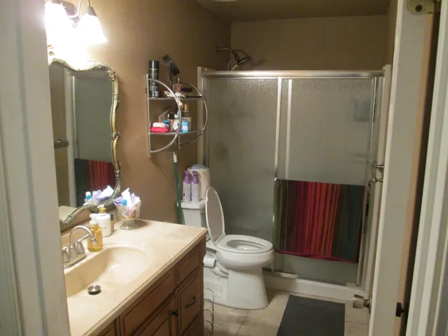 a bedroom with a bed and a mirror