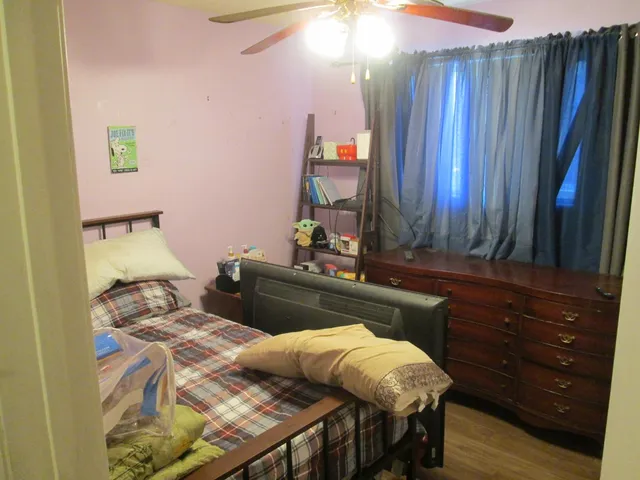 a bed sitting in a bedroom next to a window