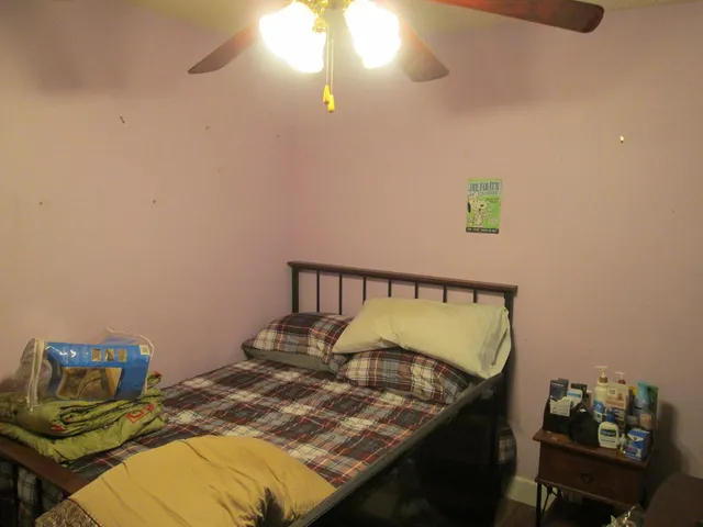 a bed sitting in a bedroom next to a window