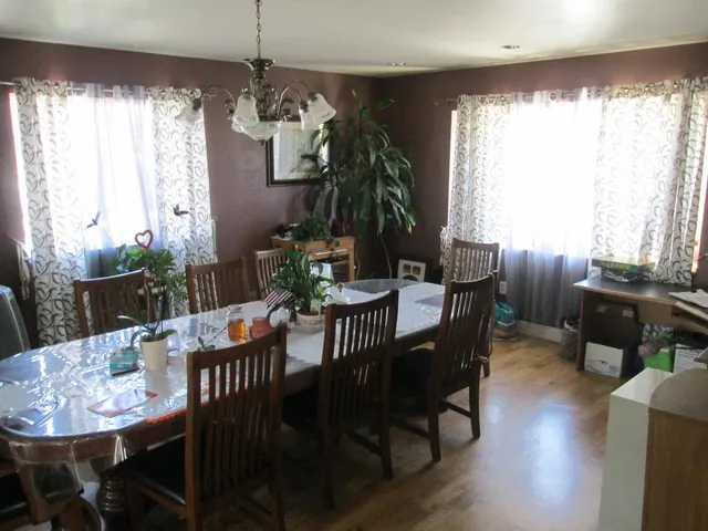 a living room with furniture a piano and a window