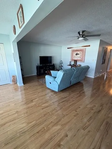 a living room with furniture and a wooden floor