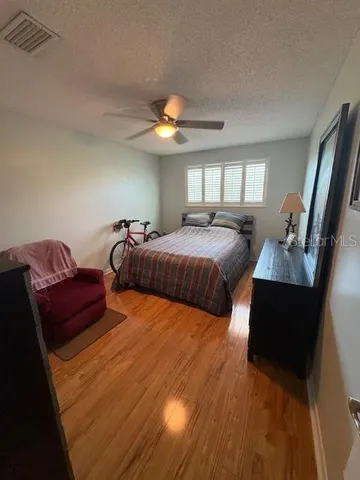 a bedroom with double bed and a chandelier