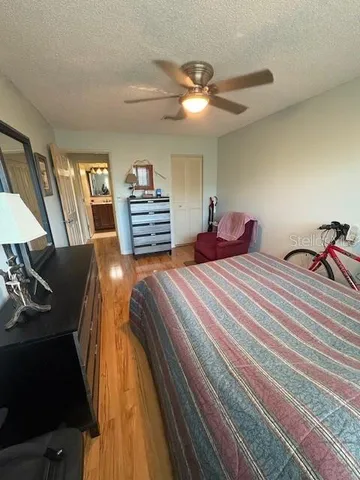 a bedroom with a bed and a chandelier