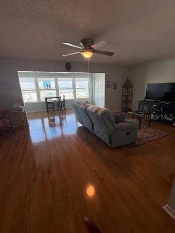 a living room with furniture and a wooden floor