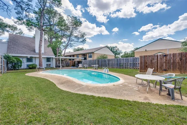 a view of a house with a yard and tree