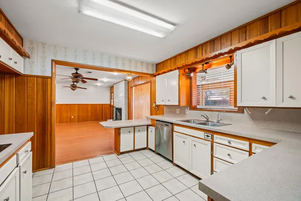 a kitchen with a sink cabinets and window