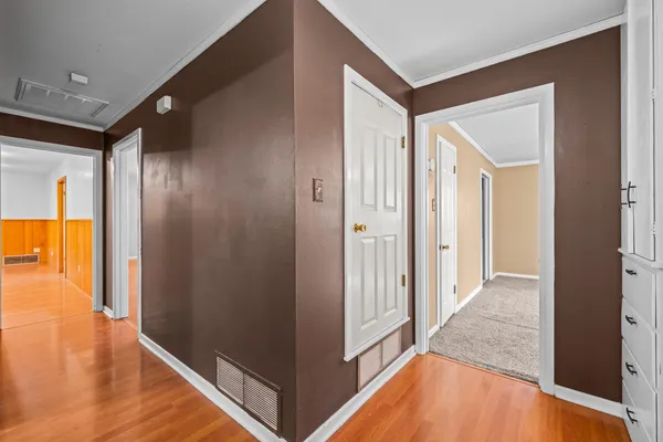 a view of a hallway with wooden floor