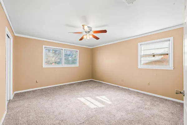a view of room with a ceiling fan and window