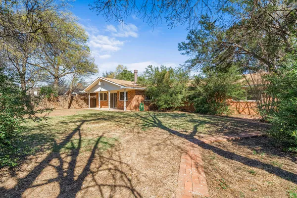 a view of outdoor space with garden and trees