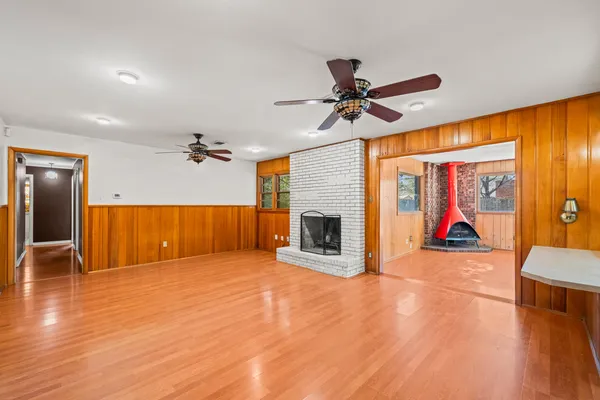 a view of a water heater room with a fireplace wooden floor