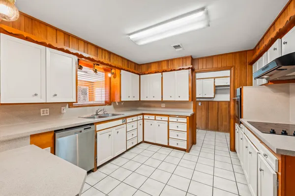 a kitchen with a sink stove and cabinets