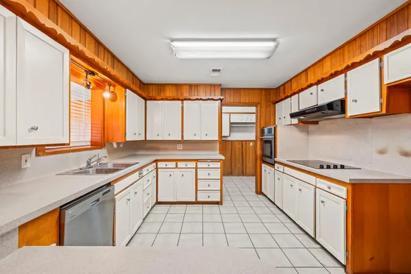 a kitchen with stainless steel appliances granite countertop a sink and a stove
