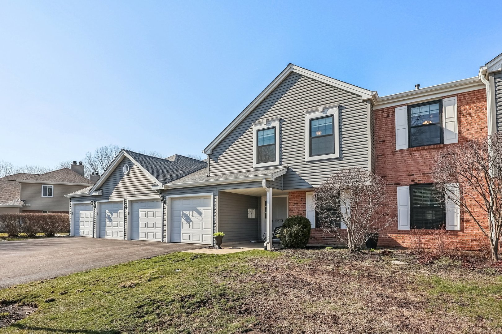 N150 Windermere Road, Unit 1306 Winfield, IL 60190 - Photo 1 of 11 a front view of a house with a yard