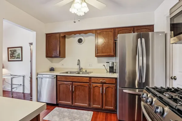 a kitchen with stainless steel appliances a sink stove and refrigerator