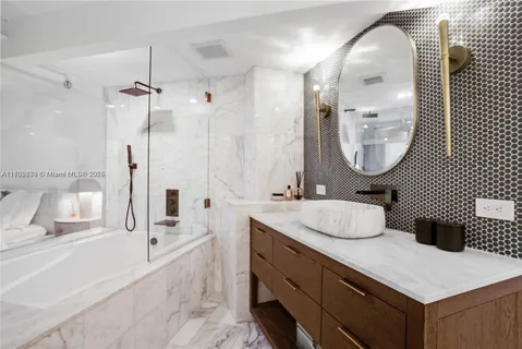 a bathroom with a double vanity sink mirror and shower