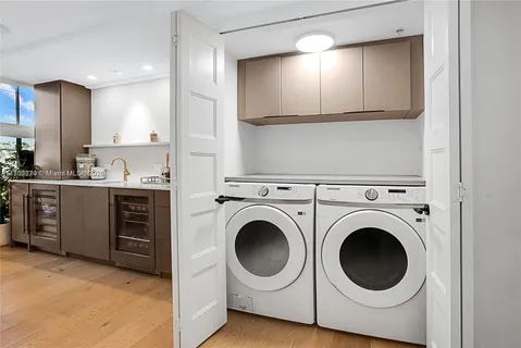 a utility room with sink dryer and washer