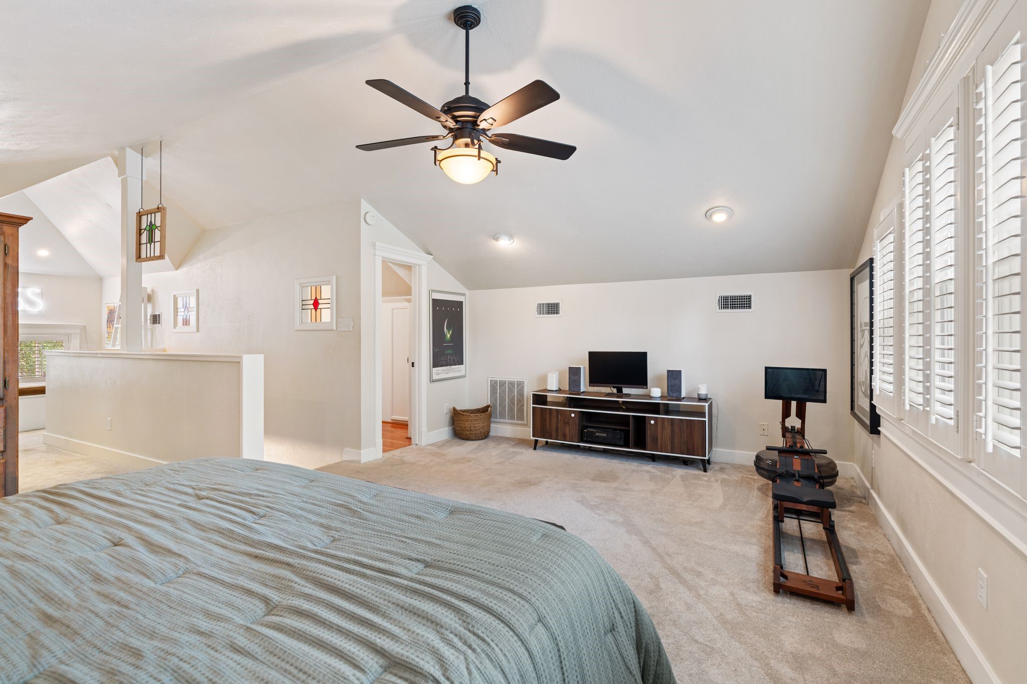 1421 Columbia Street Houston, TX 77008 - Photo 22 of 32 a large bedroom with a bed a window and a chandelier