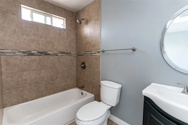 a bathroom with a sink a toilet and bathtub