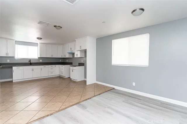 a kitchen with granite countertop a stove a sink and a granite counter top