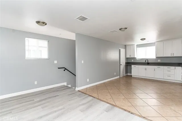 a view of a kitchen with an empty space and window