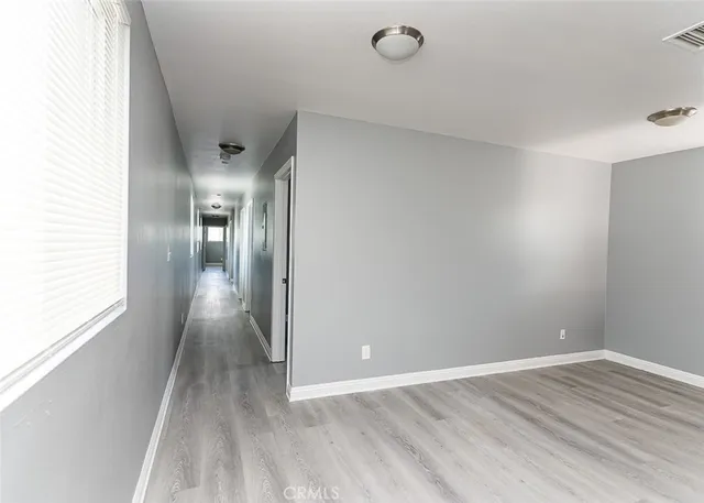 a view of hallway with wooden floor