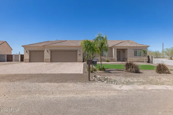 a front view of a house with a yard and garage