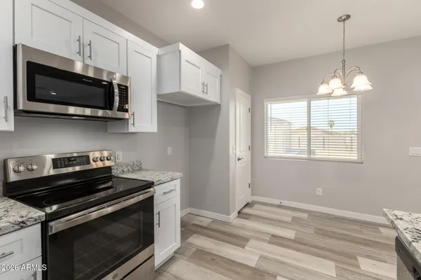 a kitchen with stainless steel appliances a stove a microwave and cabinets