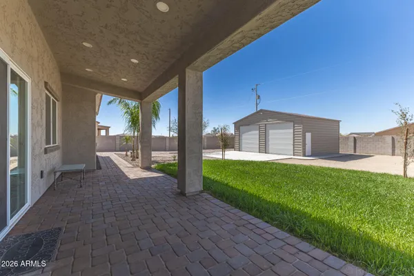 a view of a house with a yard and a garage