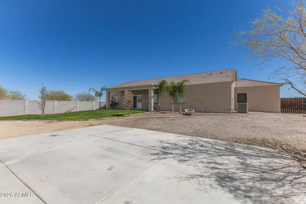 a view of a house with backyard and road