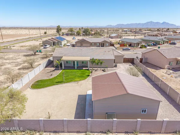 an aerial view of a house having yard patio and ocean view