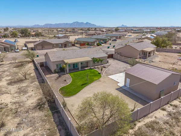 an aerial view of a house with a yard