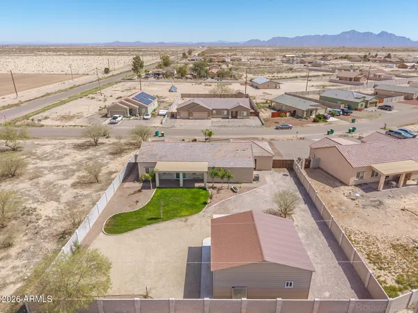 an aerial view of a house with a yard