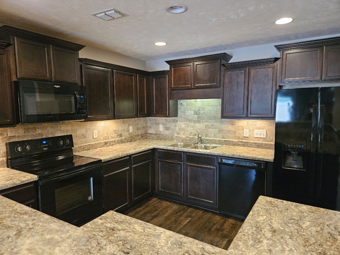4332 Prometheus Way Murfreesboro, TN 37128 - Photo 5 of 11 a kitchen with stainless steel appliances granite countertop wooden cabinets a stove top oven a granite counter top and a refrigerator