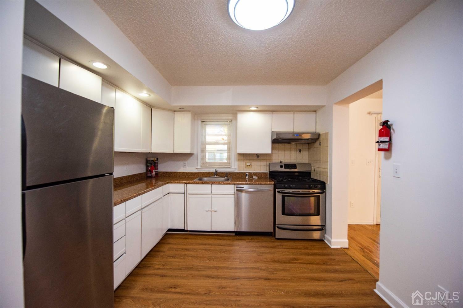 4507 Hana Road Edison, NJ 08817 - Photo 4 of 15 a kitchen with a refrigerator sink and stove top oven